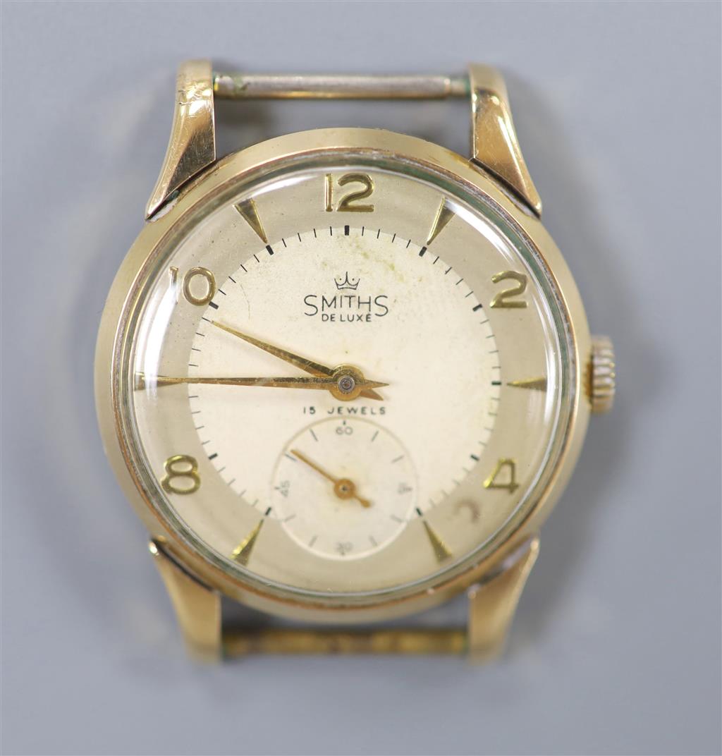 A gentlemans 9ct gold Smiths de Luxe manual wind wrist watch, no strap, case diameter 32mm, gross 23.7 grams.